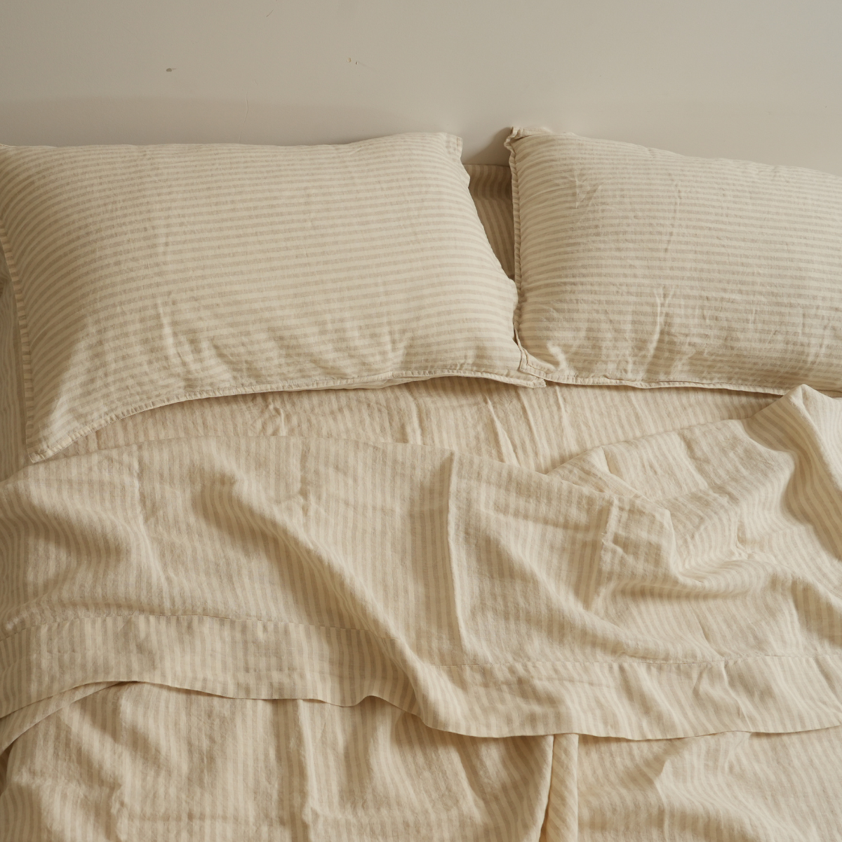 100% french flax linen sheet set in sand stripe, styled shot