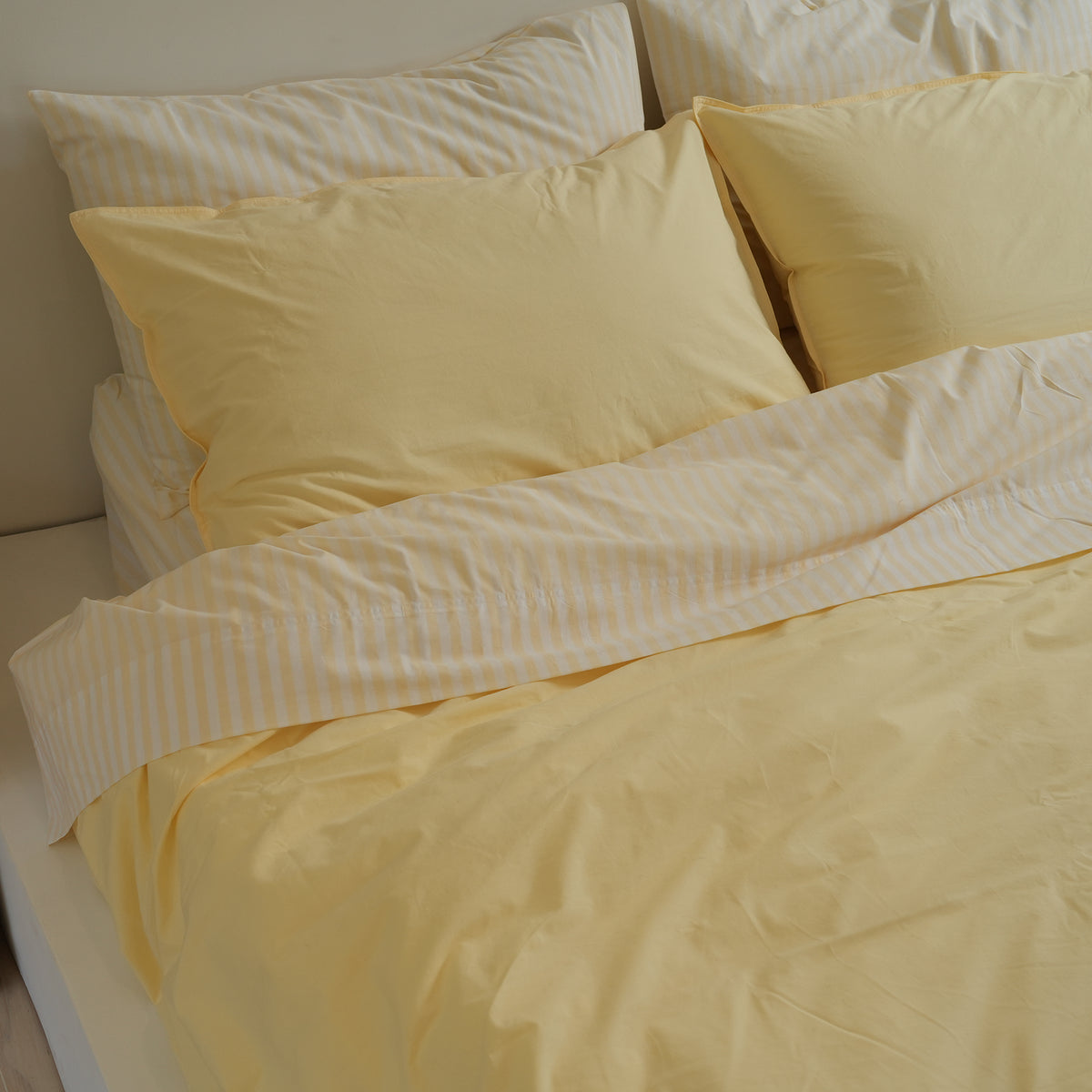 100% stonewashed cotton duvet set in butter, styled shot