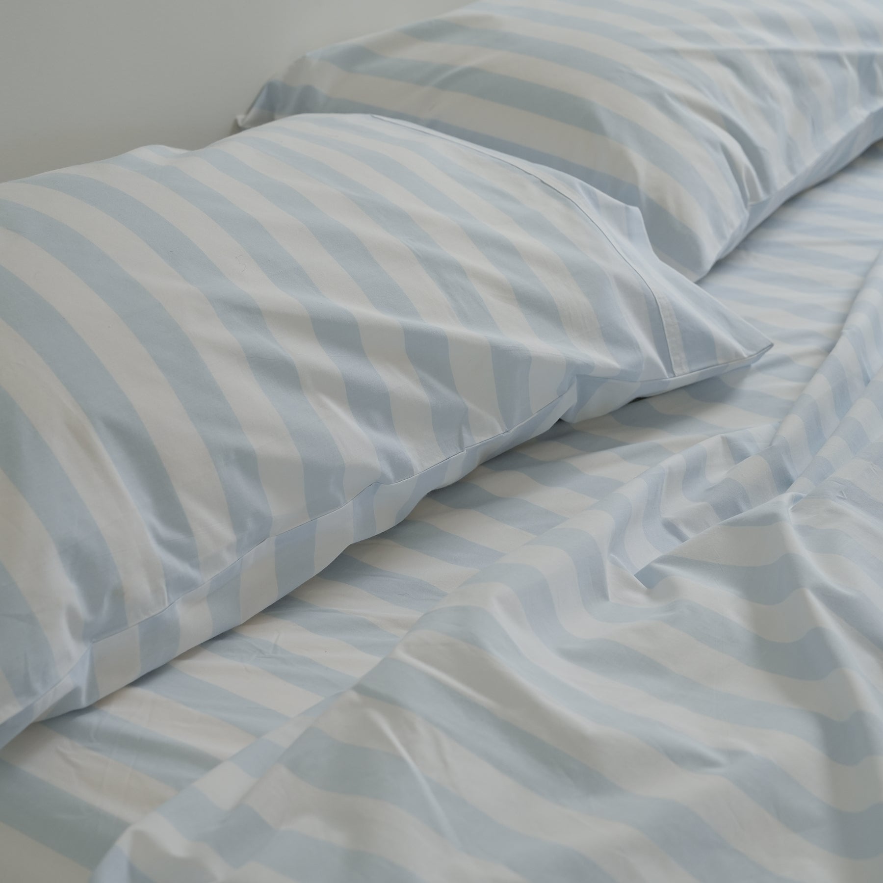 100% stonewashed cotton pillowcase pair in sky blue stripe, close-up