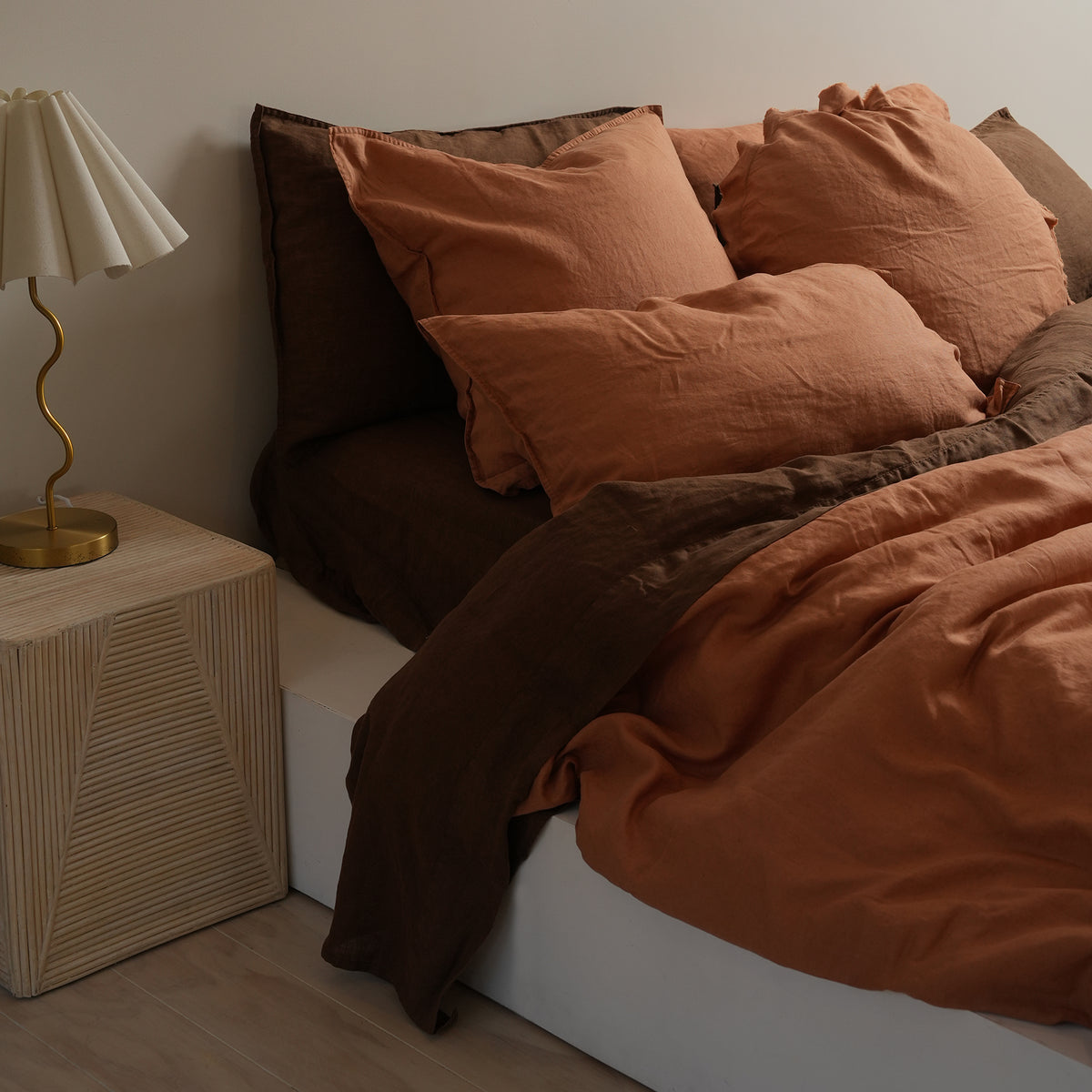 100% flax linen round feather filled cushion in hazelnut, close-up