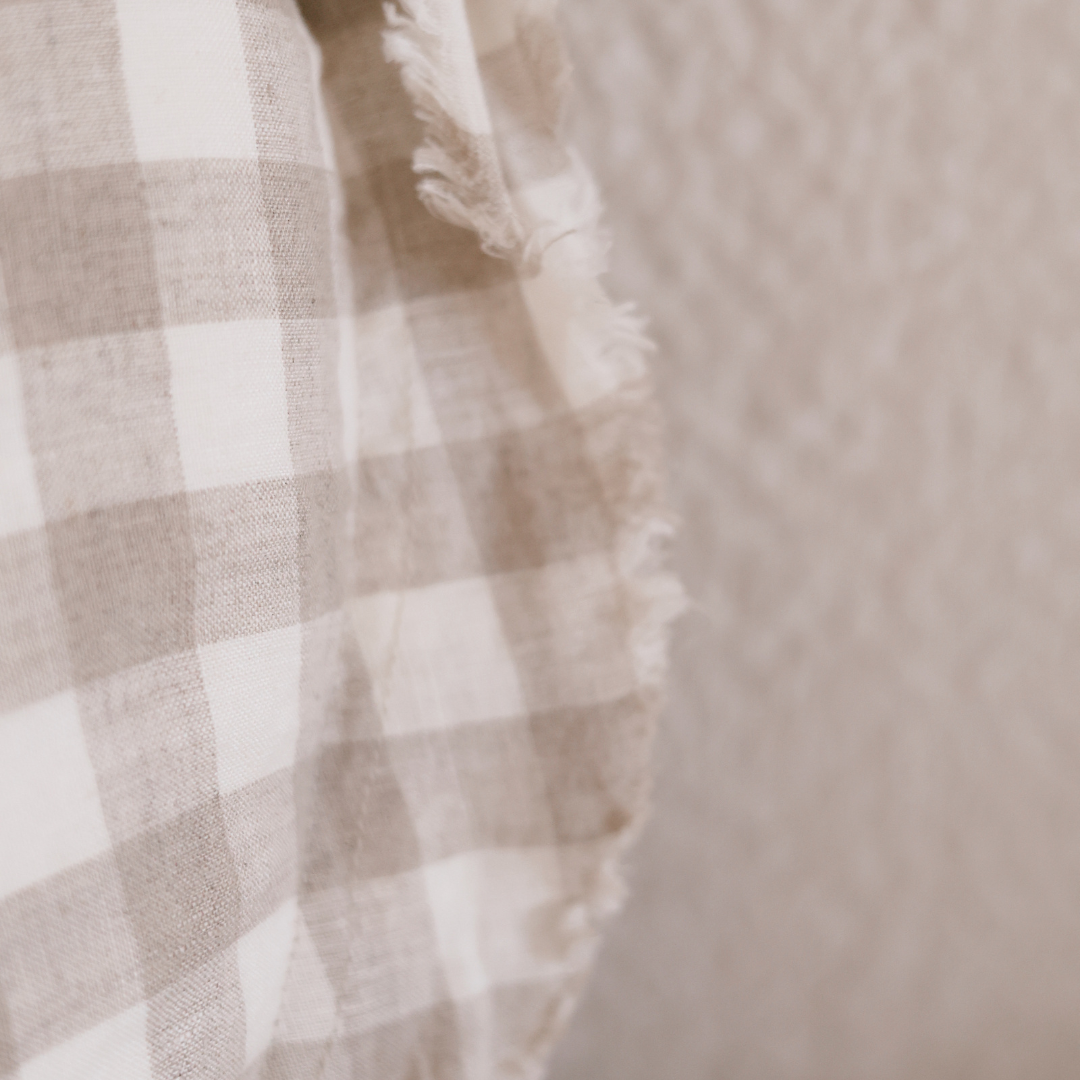 100% flax linen round feather filled cushion in natural gingham, close-up