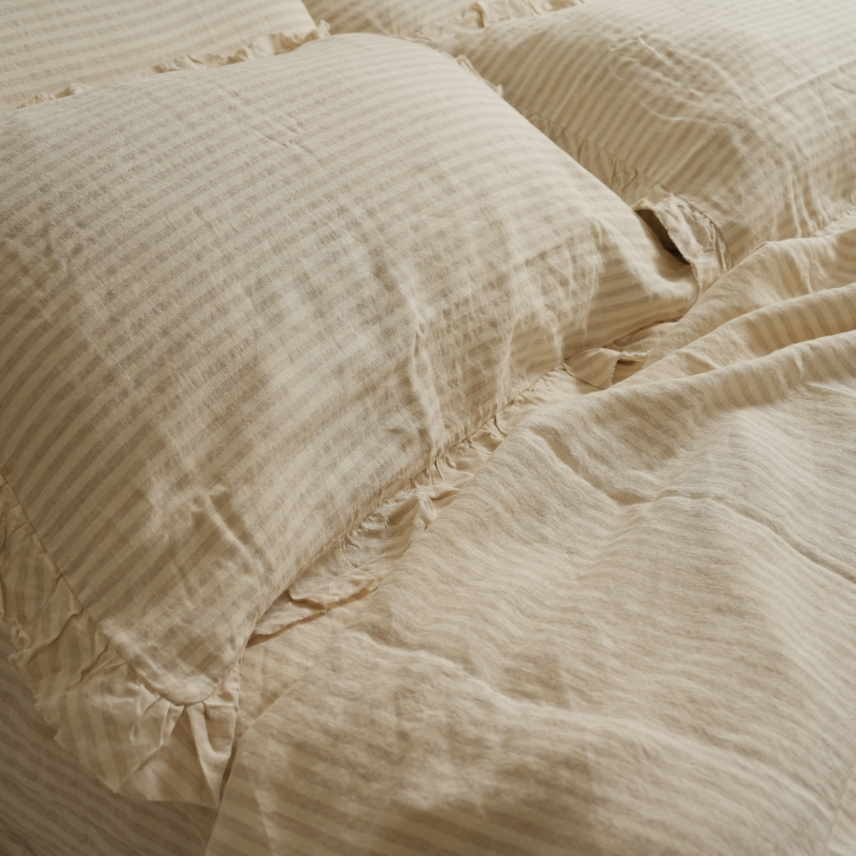 100% french flax linen ruffle edge pillowcase pair in sand stripe, styled shot