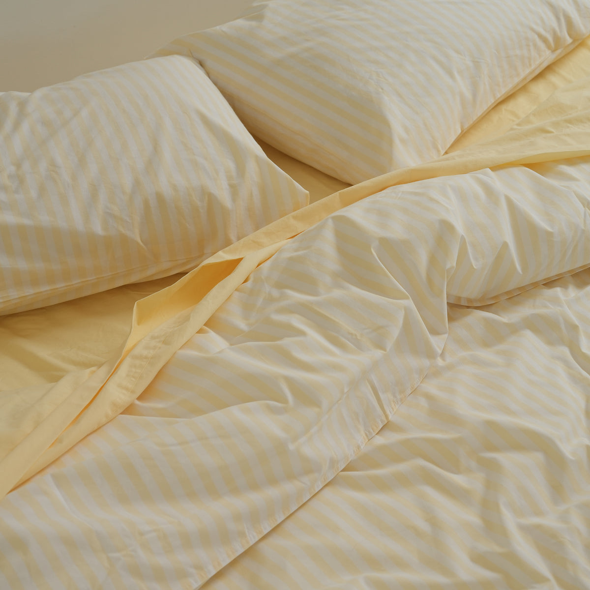 100% stonewashed cotton duvet set in butter stripe, close-up