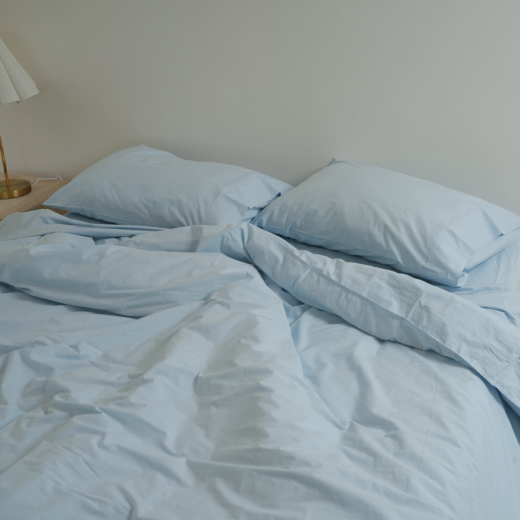 100% stonewashed cotton duvet set in sky blue, styled shot