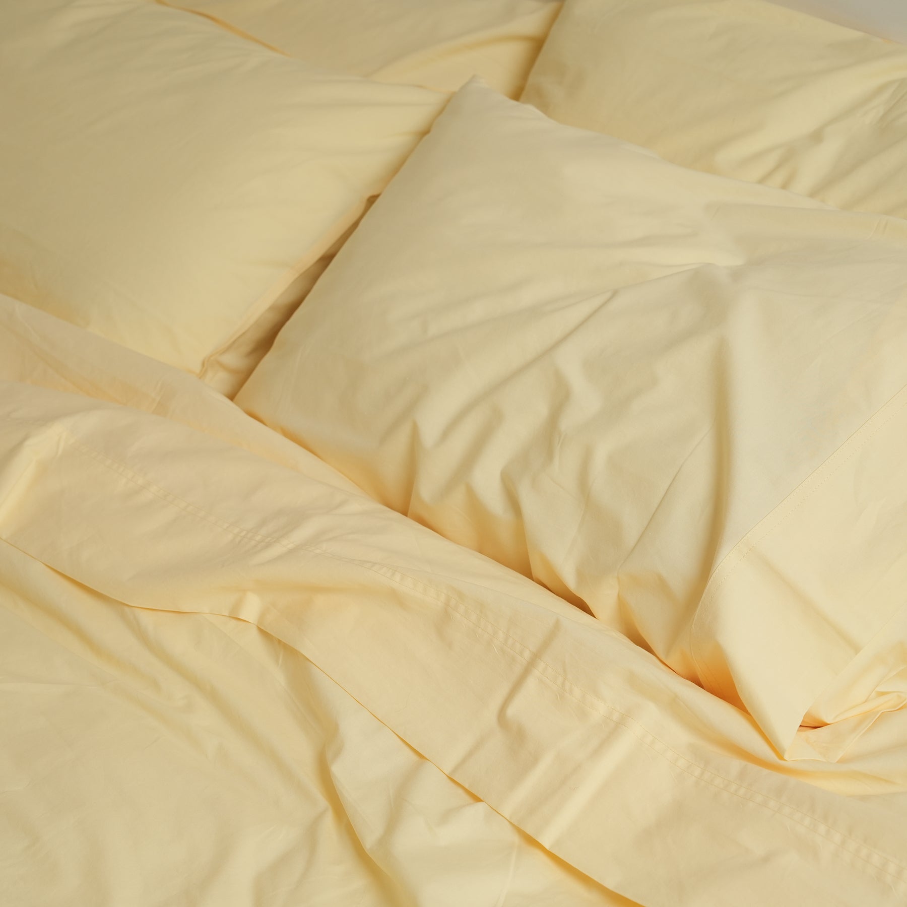 100% stonewashed cotton sheet set in butter, styled shot
