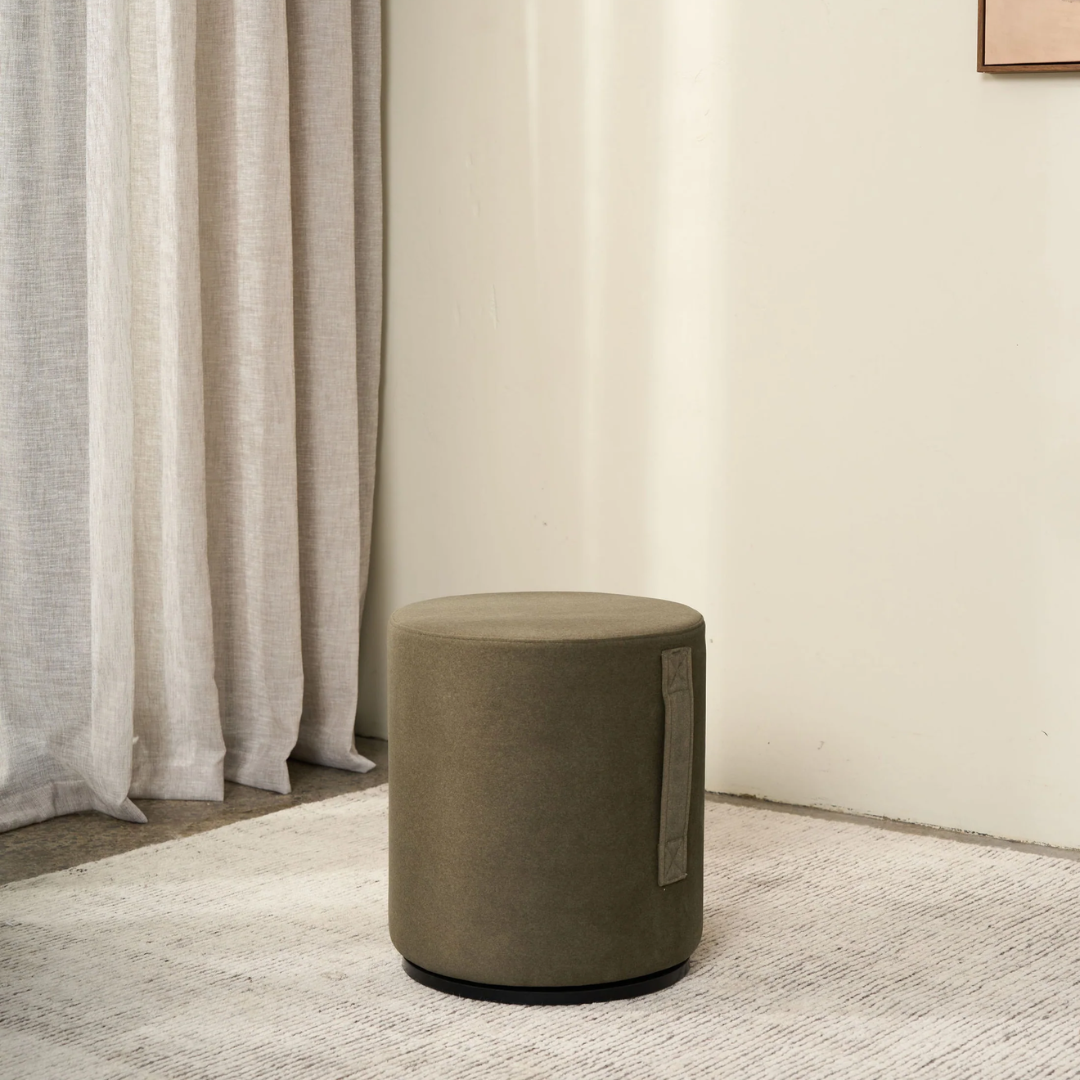 Mee swivel ottoman in Olive, compact form, smooth swivel base