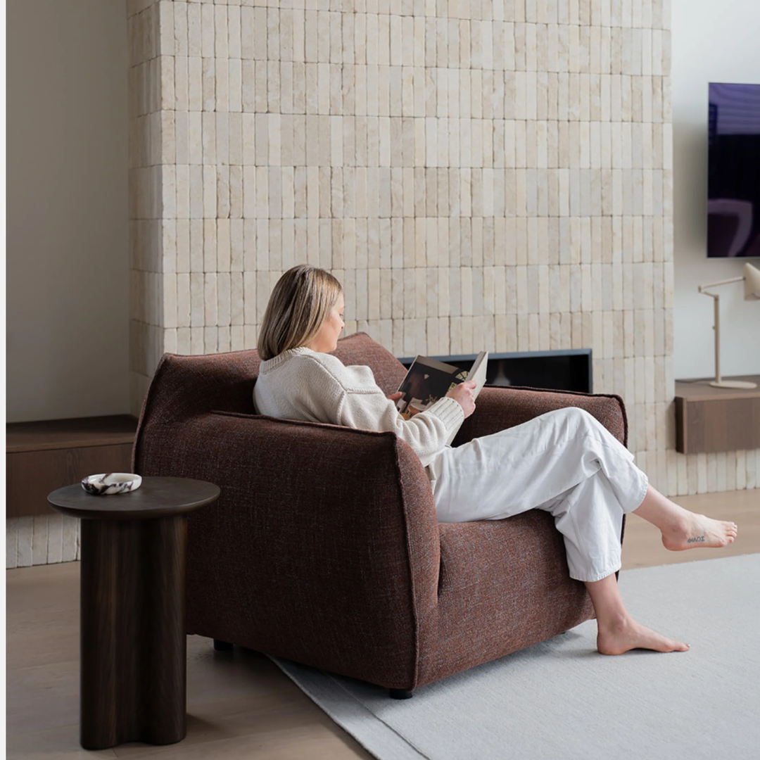 Nearly Famous armchair, rounded silhouette, plush upholstery